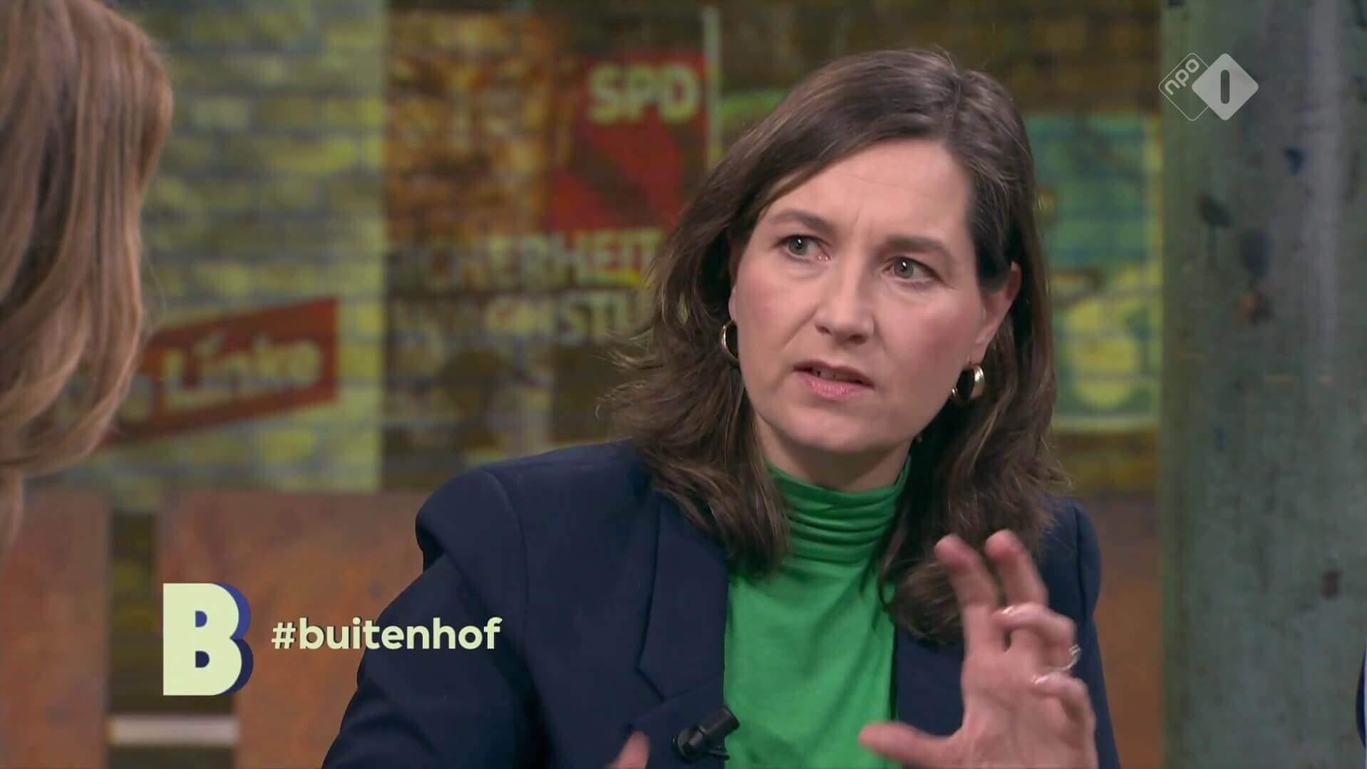 Ulrike Nagel in gesprek tijdens het tv-programma Buitenhof op NPO 1, met op de achtergrond Duitse verkiezingsposters